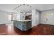 The kitchen island features stone accents, pendant lights, and a functional breakfast bar at 7911 E Posada Ave, Mesa, AZ 85212