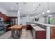 Modern kitchen featuring stainless steel appliances, an island with a breakfast bar and designer lighting at 7911 E Posada Ave, Mesa, AZ 85212