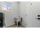 Utility sink, window and access door shown in laundry room at 7911 E Posada Ave, Mesa, AZ 85212