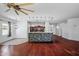 Open-concept living space with hardwood floors, view of kitchen island, and modern lighting at 7911 E Posada Ave, Mesa, AZ 85212