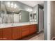 Bathroom with double sinks and a shower can be seen in the mirror at 8468 W Lewis Ave, Phoenix, AZ 85037