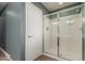Bathroom featuring a glass shower and a door at 8468 W Lewis Ave, Phoenix, AZ 85037