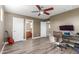 Bedroom featuring hardwood floors, a desk, and a guitar at 8468 W Lewis Ave, Phoenix, AZ 85037