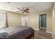 Bedroom featuring wood floors, ceiling fan, and several windows at 8468 W Lewis Ave, Phoenix, AZ 85037