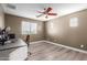 Bedroom featuring hardwood floors, a ceiling fan, and a desk at 8468 W Lewis Ave, Phoenix, AZ 85037