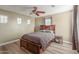 Bedroom featuring wood floors, ceiling fan, and several windows at 8468 W Lewis Ave, Phoenix, AZ 85037