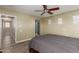Bedroom featuring wood floors, ceiling fan, and several windows at 8468 W Lewis Ave, Phoenix, AZ 85037
