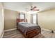 Bedroom featuring hardwood floors, a ceiling fan, and a cozy bed with matching drawers at 8468 W Lewis Ave, Phoenix, AZ 85037