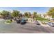 An inviting community pool area featuring ample parking, a shaded pergola, and lush landscaping perfect for relaxation at 8468 W Lewis Ave, Phoenix, AZ 85037