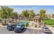 Well-maintained community pool area with a pergola, manicured landscaping, and convenient parking perfect for residents at 8468 W Lewis Ave, Phoenix, AZ 85037