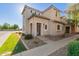 Attractive two-story home showcasing a well-kept lawn, low-maintenance landscaping, and a welcoming front entrance at 8468 W Lewis Ave, Phoenix, AZ 85037
