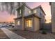 Inviting two-story home featuring warm exterior lighting, low maintenance landscaping, and a cozy, welcoming atmosphere at 8468 W Lewis Ave, Phoenix, AZ 85037