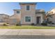 Charming two-story home featuring a well-maintained lawn, tasteful landscaping, and a neutral color palette at 8468 W Lewis Ave, Phoenix, AZ 85037