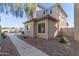 Beige two story home featuring rock landscaping, traditional windows, and tile roofing at 8468 W Lewis Ave, Phoenix, AZ 85037