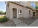 Beige home featuring rock landscaping, traditional windows, and a covered entryway at 8468 W Lewis Ave, Phoenix, AZ 85037