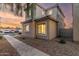 Beige two story home featuring rock landscaping, traditional windows, and tile roofing at 8468 W Lewis Ave, Phoenix, AZ 85037