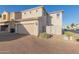 Spacious garage with brick driveway, desert landscaping and ample parking at 8468 W Lewis Ave, Phoenix, AZ 85037