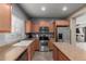 Well-lit kitchen with stainless steel appliances, neutral countertops and cabinets, and an island at 8468 W Lewis Ave, Phoenix, AZ 85037