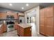 An open-plan kitchen and living area with stainless steel appliances and access to the patio at 8468 W Lewis Ave, Phoenix, AZ 85037