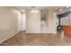 Open-concept living area featuring tile floors, a staircase, and plenty of natural light at 8468 W Lewis Ave, Phoenix, AZ 85037