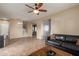 Spacious living area with tile flooring, stairs to upper level, and open layout at 8468 W Lewis Ave, Phoenix, AZ 85037