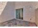 Enclosed patio area offering privacy and featuring a sliding glass door at 8468 W Lewis Ave, Phoenix, AZ 85037