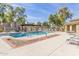 Community pool area featuring a pool, pergola, and lounge chairs, creating a relaxing oasis at 8468 W Lewis Ave, Phoenix, AZ 85037