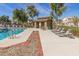 Community swimming pool and cabana with lounge chairs and well-kept grounds at 8468 W Lewis Ave, Phoenix, AZ 85037