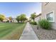 Community street with walkway and green space, providing a scenic and pedestrian-friendly environment at 8468 W Lewis Ave, Phoenix, AZ 85037