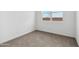 Cozy bedroom with neutral carpet, clean white walls, natural light from the window, and outlets at 8516 W Clemente Way, Florence, AZ 85132