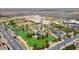 Aerial view of community park featuring a lake, playground, walking paths, open green space, and surrounding neighborhood at 8516 W Clemente Way, Florence, AZ 85132