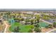 Aerial view of the community park featuring a lake and a play area at 8516 W Clemente Way, Florence, AZ 85132