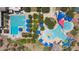 Aerial view of the community pool with multiple swimming areas, sunshades, lounge chairs, and lush landscaping at 8516 W Clemente Way, Florence, AZ 85132