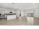Spacious living area with tile flooring adjacent to the kitchen and a sliding glass door at 8516 W Clemente Way, Florence, AZ 85132