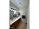 Bathroom featuring double sinks with a large mirror and good lighting at 8820 W Glenn Dr, Glendale, AZ 85305