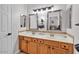 Bright bathroom features a double vanity with wood cabinets and dual sinks at 8820 W Glenn Dr, Glendale, AZ 85305
