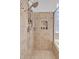 Walk-in shower with sleek fixtures, tiled walls, and a built-in niche for toiletries at 8820 W Glenn Dr, Glendale, AZ 85305