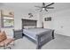 Bedroom featuring a large bed, side tables, and a chair, plus plenty of natural light at 8820 W Glenn Dr, Glendale, AZ 85305