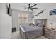 Comfortable bedroom with a large window, modern fan, and stylish decorations at 8820 W Glenn Dr, Glendale, AZ 85305