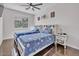 Cozy bedroom with two beds, a ceiling fan, and natural light from the window at 8820 W Glenn Dr, Glendale, AZ 85305