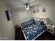 Bright bedroom with two beds, ceiling fan, mounted television, and fun space-themed decor at 8820 W Glenn Dr, Glendale, AZ 85305
