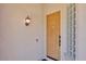 Inviting front entry with a classic wooden door and a stylish wall-mounted lantern at 8820 W Glenn Dr, Glendale, AZ 85305