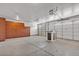 Clean and organized garage featuring storage solutions and an automatic door opener at 8820 W Glenn Dr, Glendale, AZ 85305