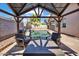Backyard gazebo with outdoor seating and a view of the sparkling pool at 8820 W Glenn Dr, Glendale, AZ 85305