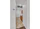 Bright hallway featuring tile flooring, white trim, and access to storage and rooms at 8820 W Glenn Dr, Glendale, AZ 85305