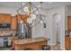 Eat-in kitchen with modern lighting, stainless appliances, and wooden cabinetry at 8820 W Glenn Dr, Glendale, AZ 85305