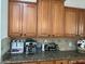 Kitchen with a coffee bar featuring a coffee maker, pods, syrups, and water bottles at 8820 W Glenn Dr, Glendale, AZ 85305