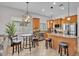 Bright kitchen with stainless appliances, granite counters, island, and pendant lighting at 8820 W Glenn Dr, Glendale, AZ 85305
