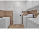 Well-organized laundry room with washer, dryer, sink, and storage cabinets at 8820 W Glenn Dr, Glendale, AZ 85305