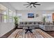 Spacious living room featuring a comfortable gray sofa, modern decor, and abundant natural light at 8820 W Glenn Dr, Glendale, AZ 85305